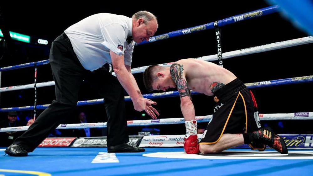 Phil Edwards counts a knocked down Lee Clayton during a boxing match