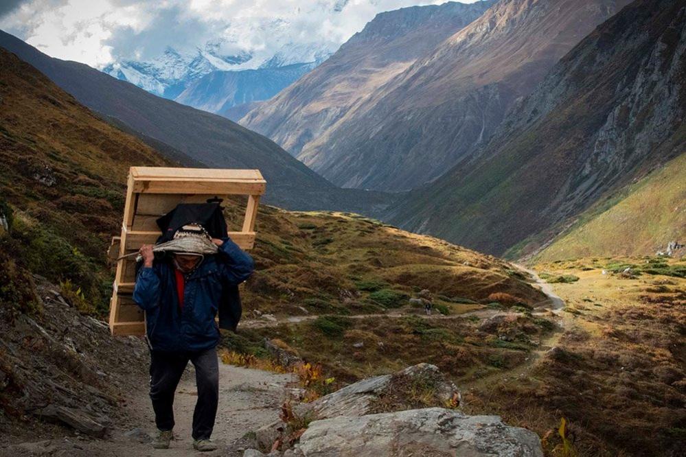 Man carrying a picture in the mountains