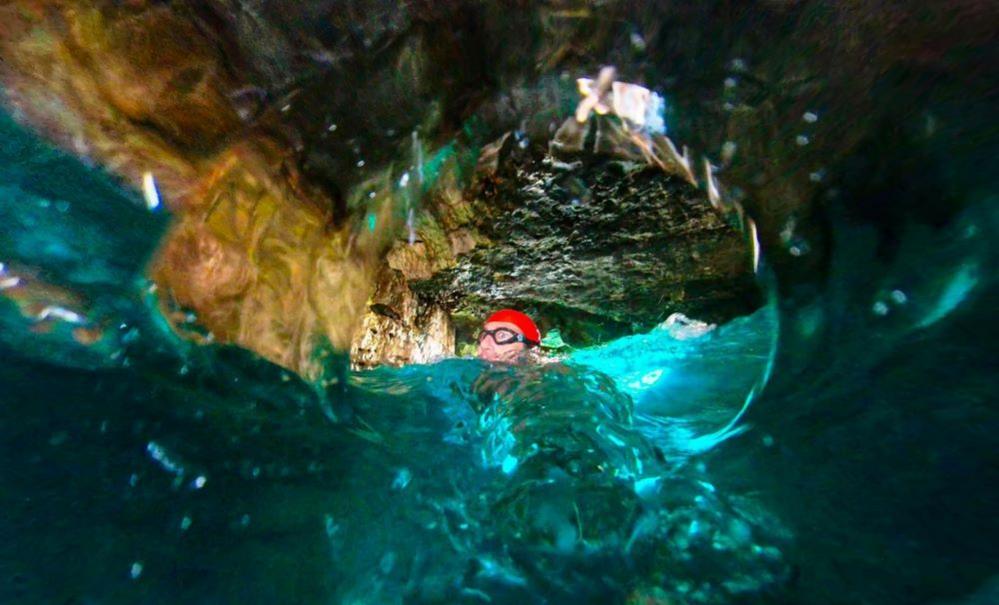 Man swimming through a tunnel