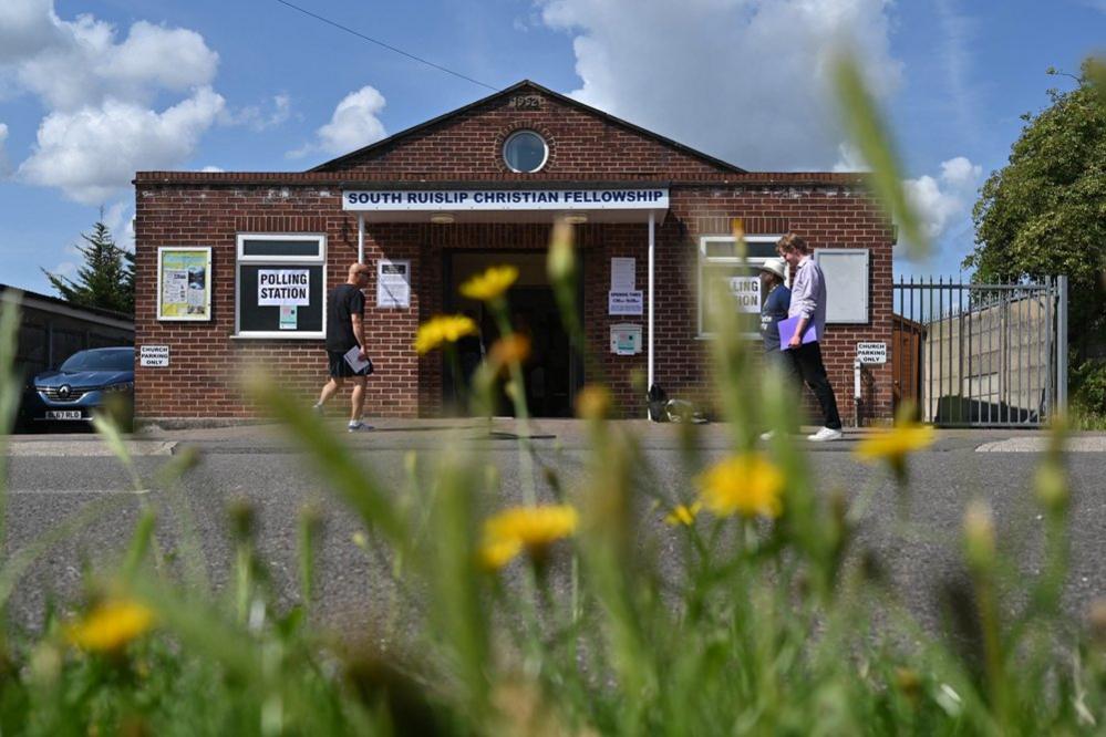 Voters go in and out of the South Ruislip Christian Fellowship being used as a polling station during a by-election in the northwest London constituency of Uxbridge and South Ruislip