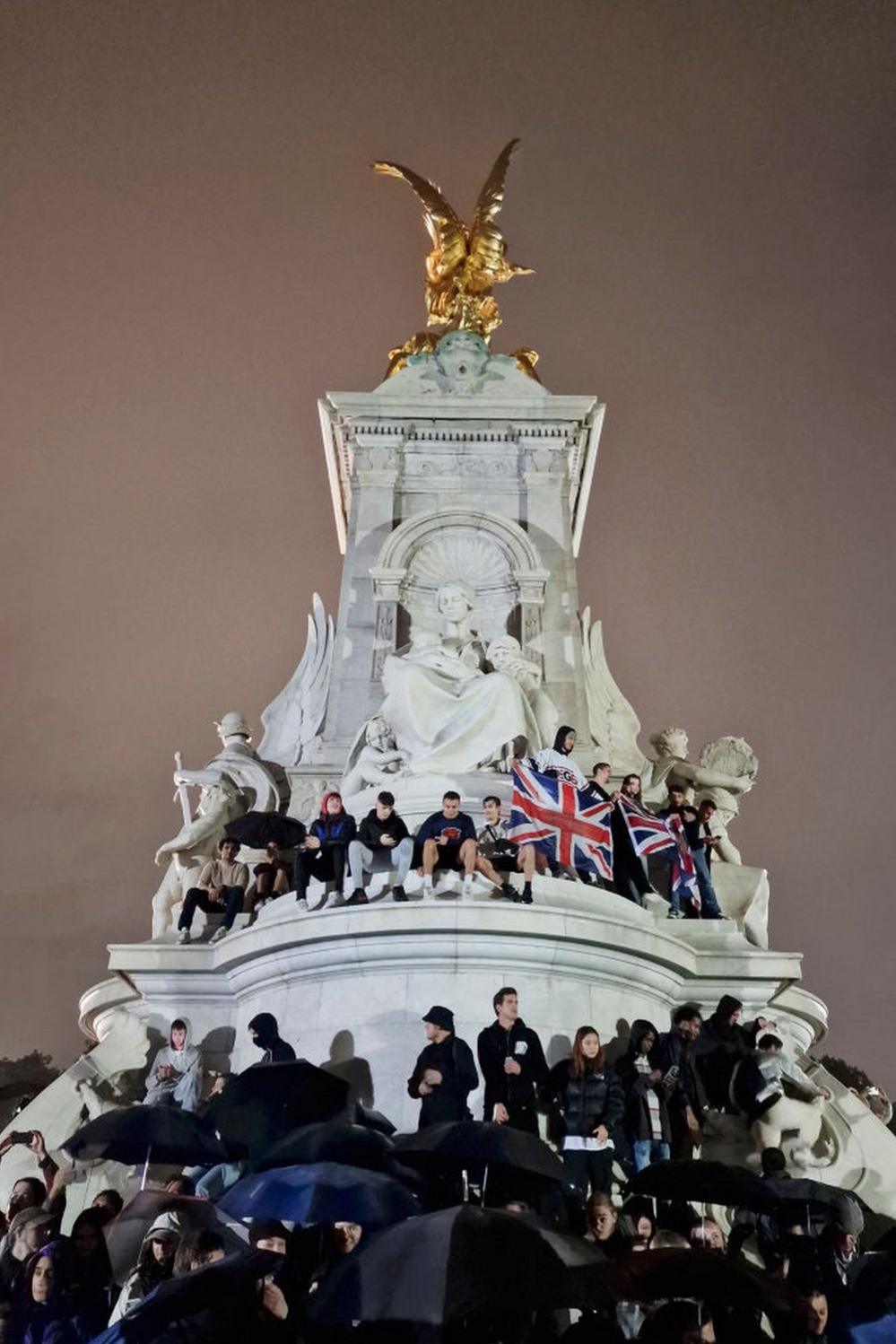 Flags are unfurled by crowds on the Queen Victoria Memorial