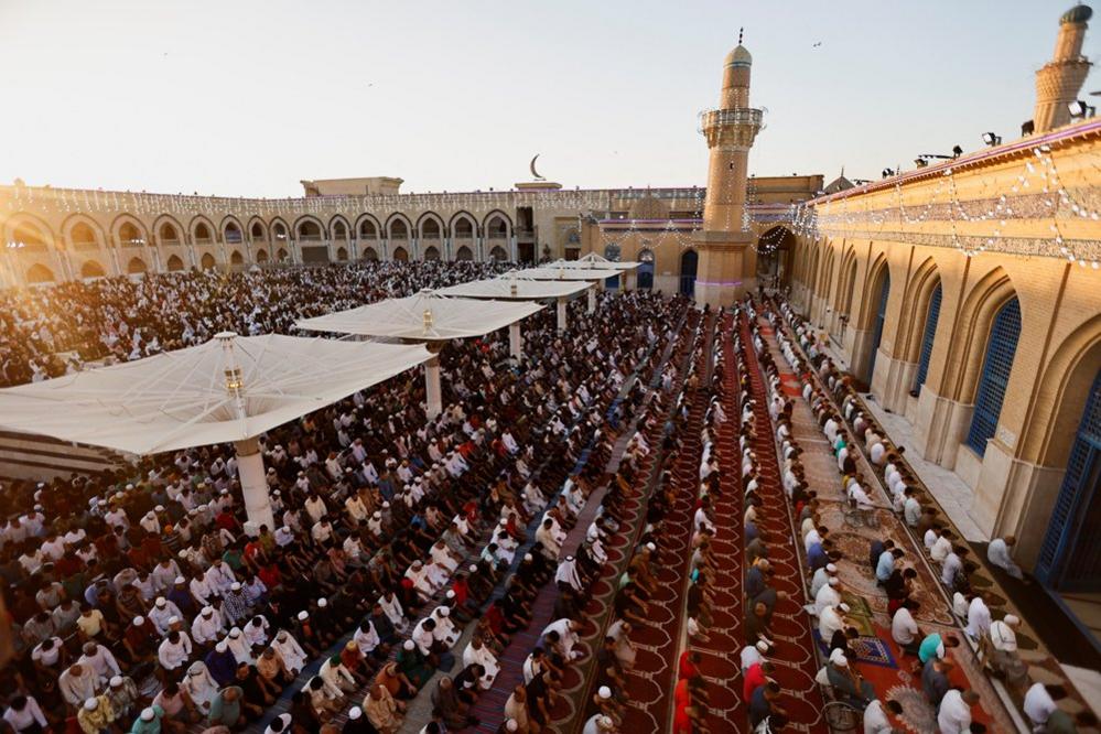 Sunni Muslim worshippers pray on the first day of the Eid al-Adha festival, at the shrine of cleric Sheikh Abdul Qadir al-Gilani in Baghdad, Iraq