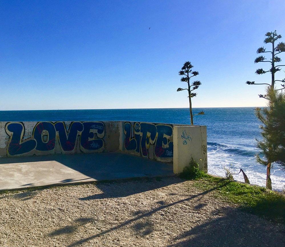 Love Life graffiti on a seawall