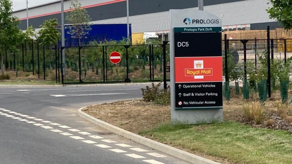 Entrance to Royal Mail hub, showing sign and gates