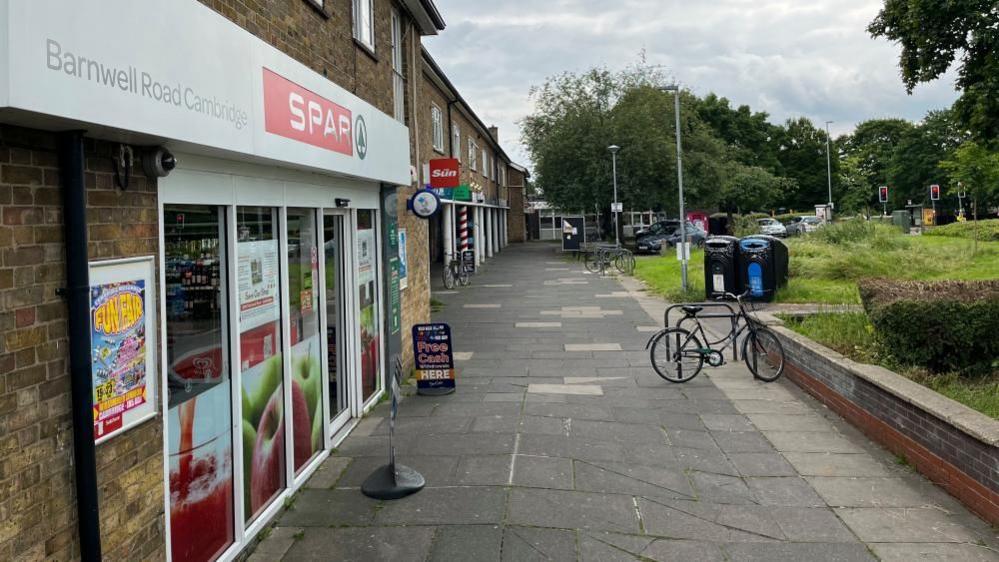 Cycle outside parade of shops