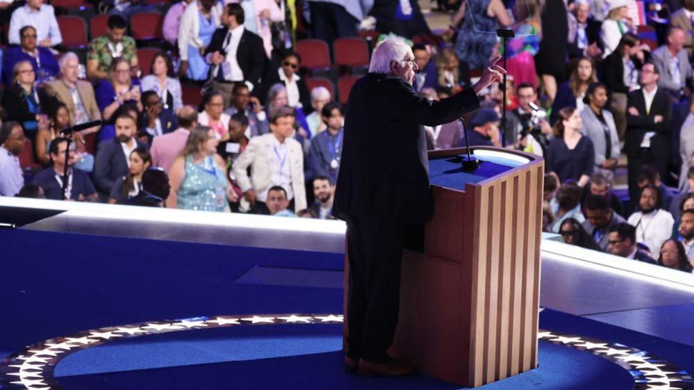 Bernie Sanders addresses the Democratic National Convention, with some empty seats visible