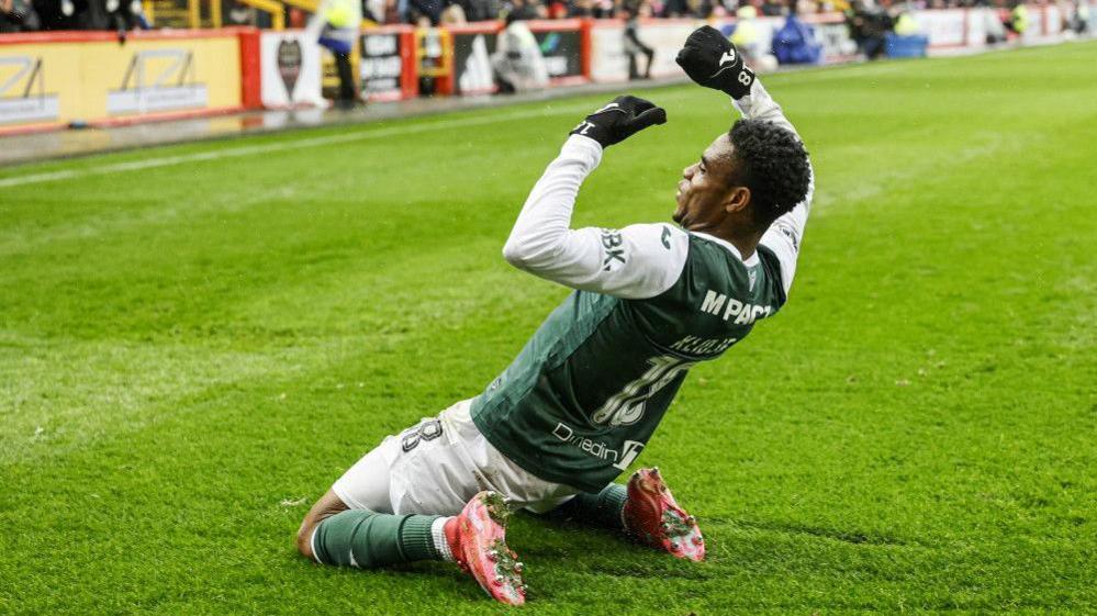 Thibault Klidje slides on his knees in celebration