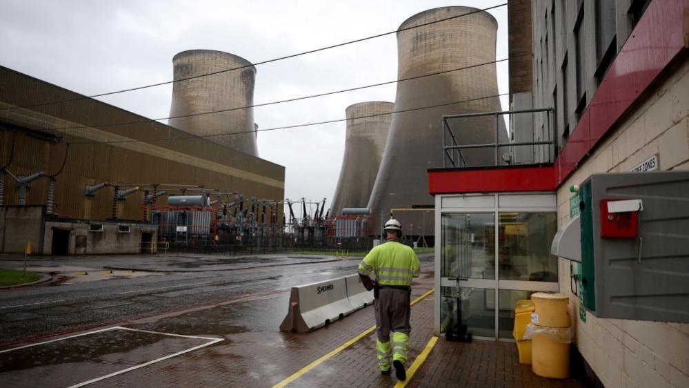A man in a hi-vis walks through the site of Ratcliffe-on-Soar on 1 October 2024.