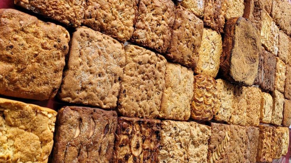 A table full of Dorset apple cake made up of scores of individual squares