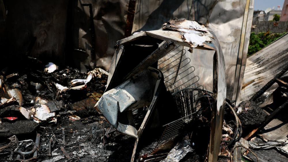 Wreckage lies in the garden of a house hit in rocket attacks from Lebanon, amid ongoing cross-border hostilities between Hezbollah and Israeli forces, in Kiryat Shmona, northern Israel, June 4, 2024.