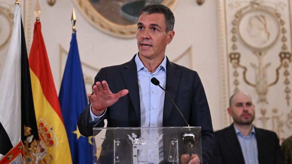 Pedro Sanchez speaking at a news conference 