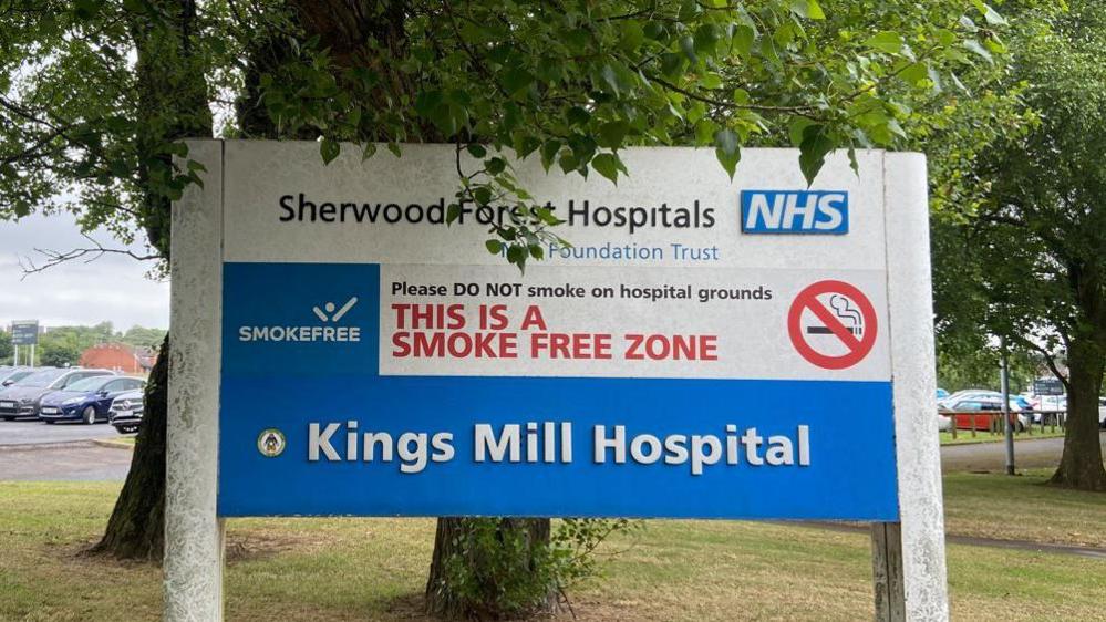 Sign of Kings Mill Hospital in Mansfield with trees in the background.