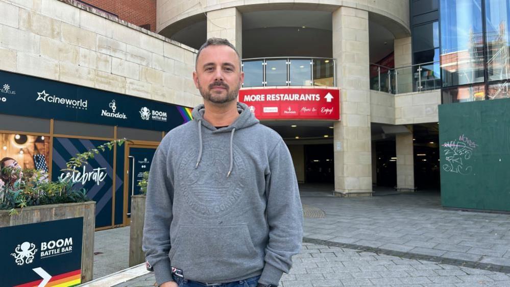 Kris Talikowski, the Old Town Business Association chairman, stands in front of Regent Circus in Swindon town centre.