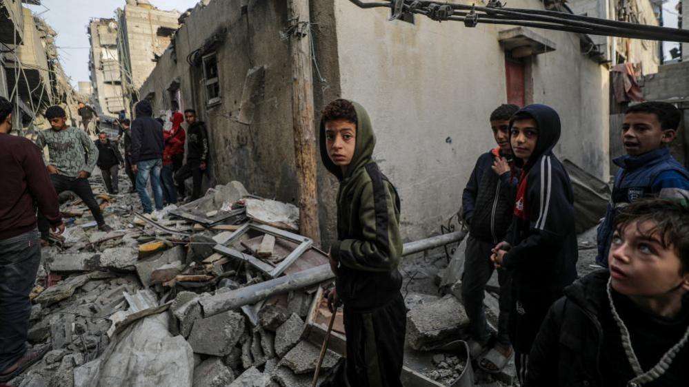 Palestinians inspect the rubble of destroyed buildings following Israeli airstrikes on Nuseirat refugee camp in Gaza (07/12/24)