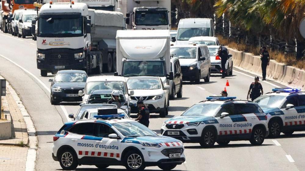 Catalan regional police force Mossos d'Esquadra stop vehicles at a roadblock in Barcelona, Spain, 08 August 2024