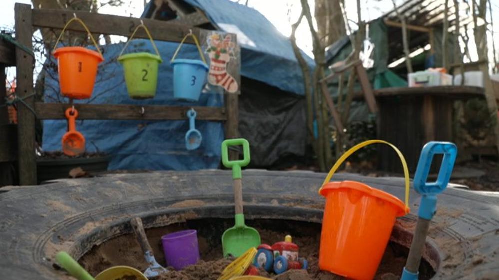 Photograph of toys in a sandpit