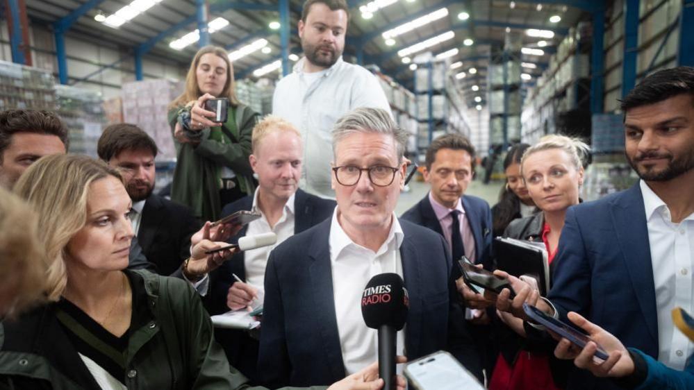 Labour leader Sir Keir Starmer surrounded by reporters