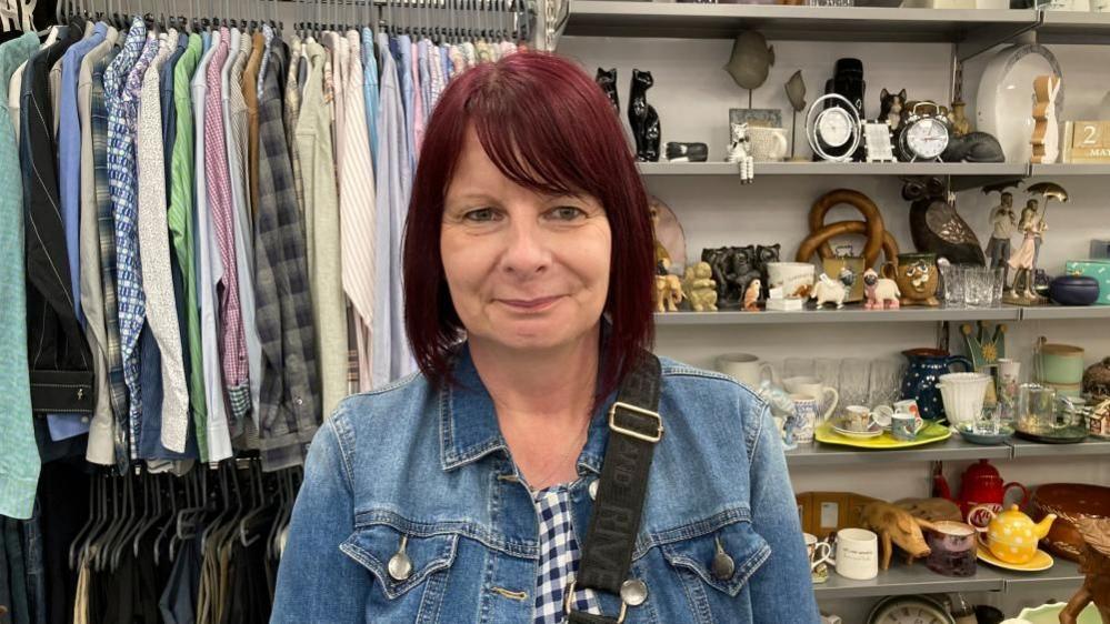 Beverley Pateman with long red hair wearing a denim jacket