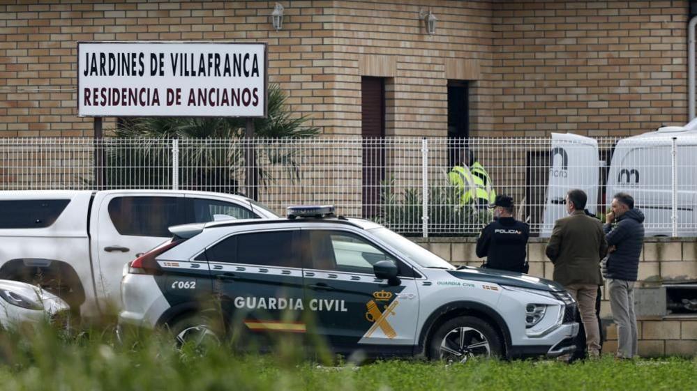 Police stand outside the Jardines De Villafranca retirement home near Zaragoza after a fire leaves 10 people dead