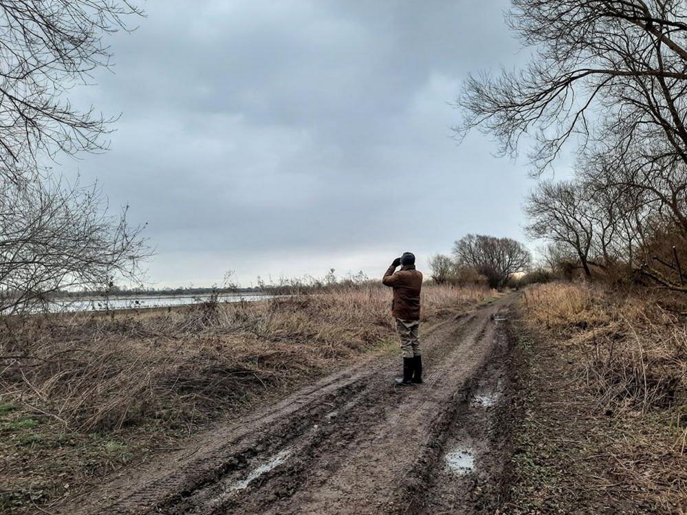 Man with binoculars on a country path