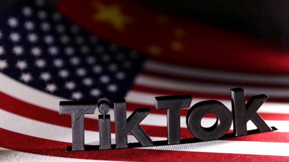 A stock image shows a 3D version of the TikTok logo stood on the flags of the US and China. 