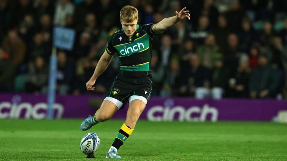 Fin Smith kicks a conversion for Northampton Saints 