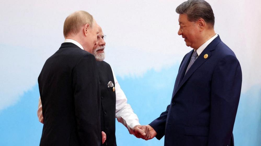 Russian President Vladimir Putin, Indian Prime Minister Narendra Modi and Chinese President Xi Jinping speak during a meeting at the Shanghai Cooperation Organisation (SCO) summit in Tianjin, China on 1 September, 2025.