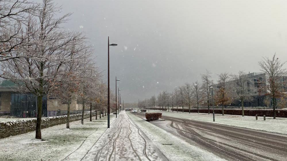 A light covering of snow visible on a street