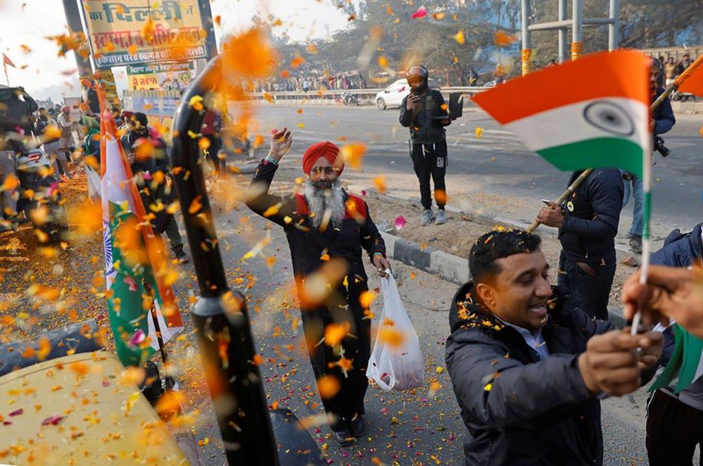 Farmers are showered with flower petals