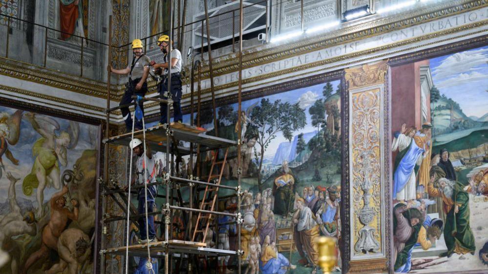 Image shows workers setting up scaffolding as they prepare for the chimney installation at the Sistine Chapel, ahead of the conclave
