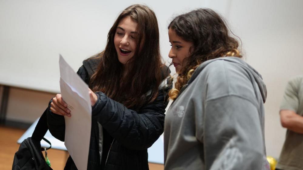 Kalina Miteva (left), with Sophia Gayle, receiving her GCSE results at Ark Pioneer in Barnet, north London