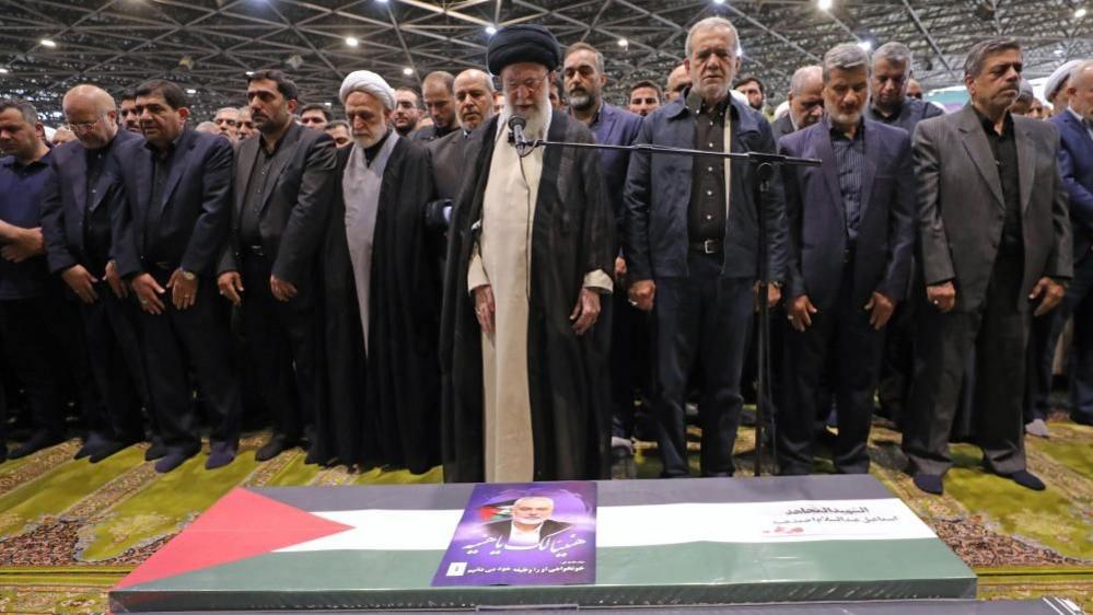 Iran's Supreme Leader Ayatollah Ali Khamenei and others stand behind coffin of assassinated Hamas leader Ismail Haniyeh in Tehran (01/08/24)