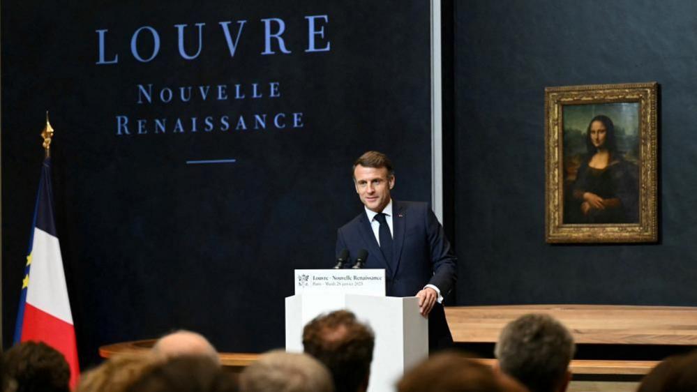 France's President Emmanuel Macron speaks at the Louvre Museum, with the Mona Lisa painting seen behind him. Photo: 28 January 2025