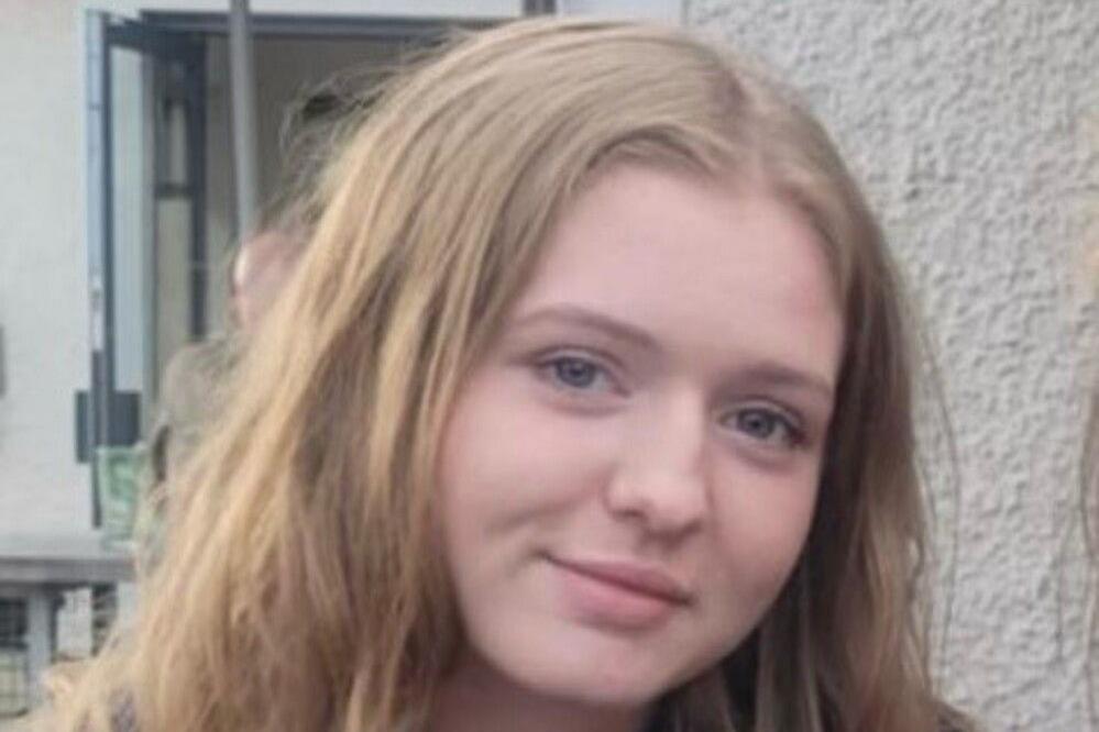 A woman with light brown hair smiles at the camera