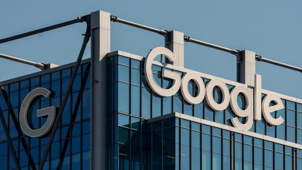 The Google logo in white lettering is visible on a dark glass office building in the US city of Atlanta, Georgia