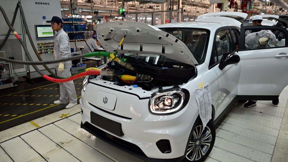 Electric vehicles being assembled at a factory in China