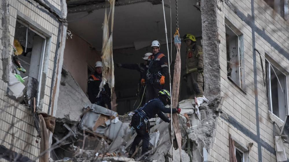 Rescuers work at the site of the apartment buildings hit during the Russian drone strike, amid Russia's attack on Ukraine, in Dnipro, Ukraine November 8, 2025. 