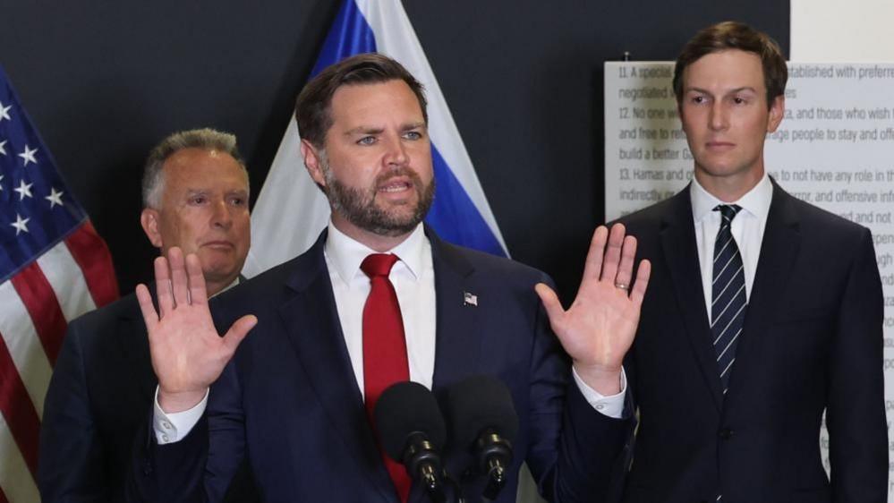 US Vice-President JD Vance (centre) speaks at a press conference in southern Israel. US special envoys Steve Witkoff (left) and Jared Kushner(right) stand behind Vance. Photo: 21 October 2025
