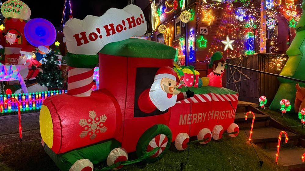 An inflatable Santa inside an inflatable train.