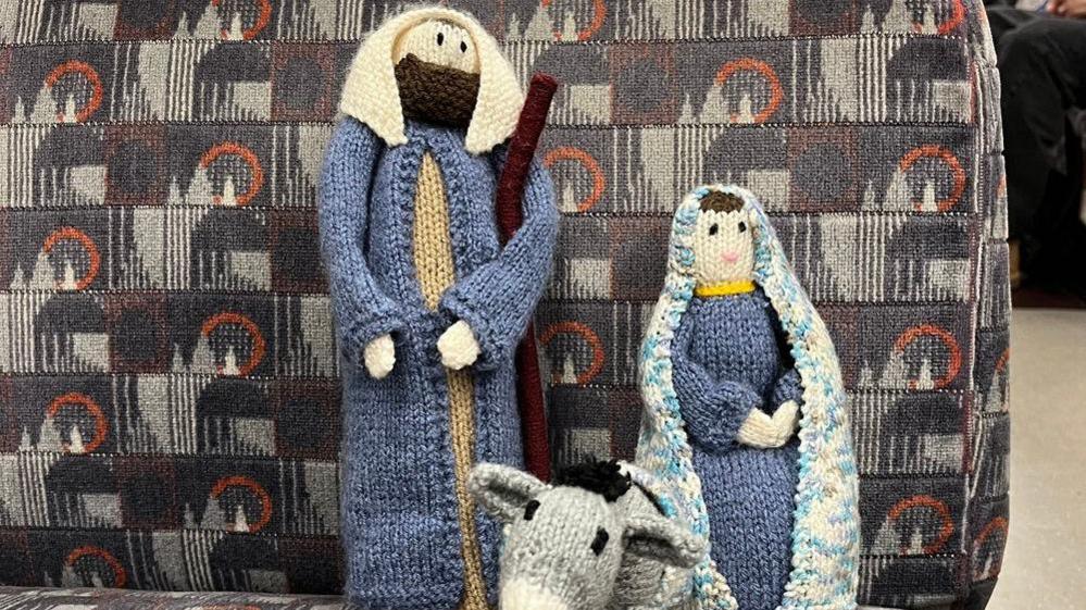 Miniature knitted figurines of Mary, Joseph and a donkey on the London travel network.