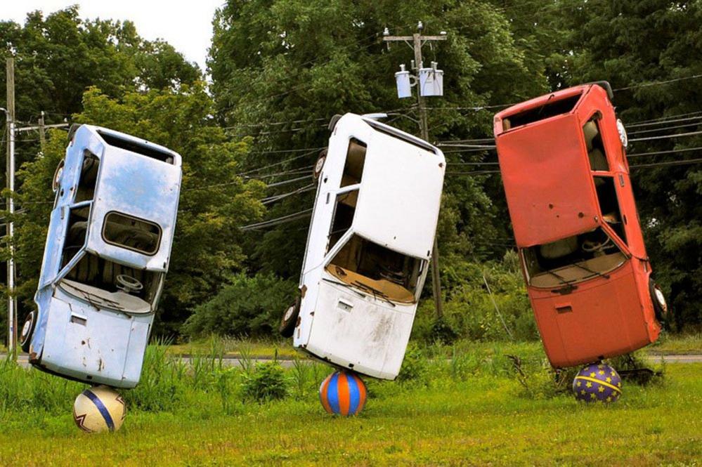 Three cars balanced to form a sculpture