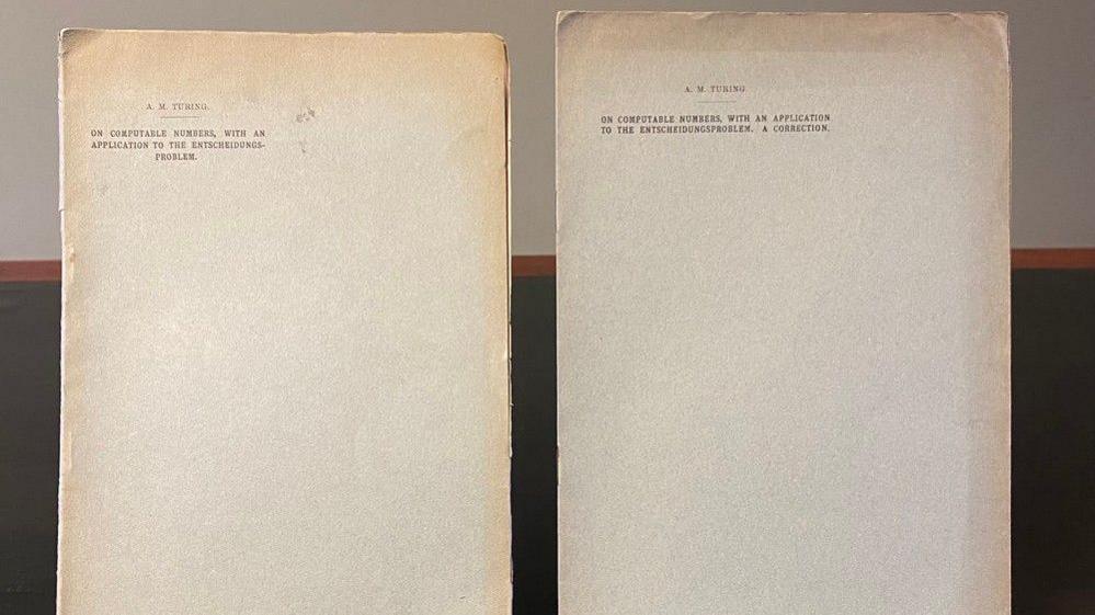 Two old papers, slightly yellowing due to their age, with type-written words on the front, including Turing's name.