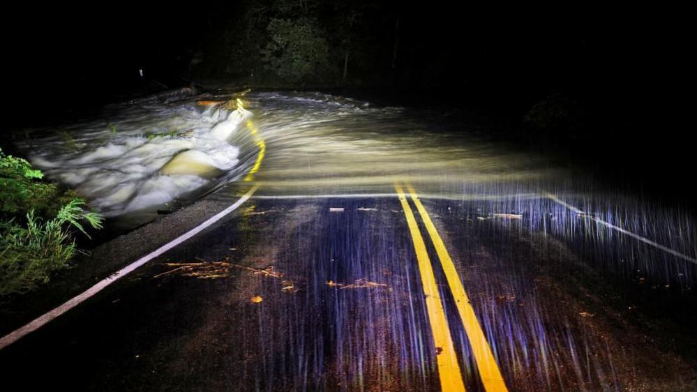 Flood waters wash over Guy Ford Road bridge on the Watauga River as Hurricane Helene approaches the North Carolina mountains 