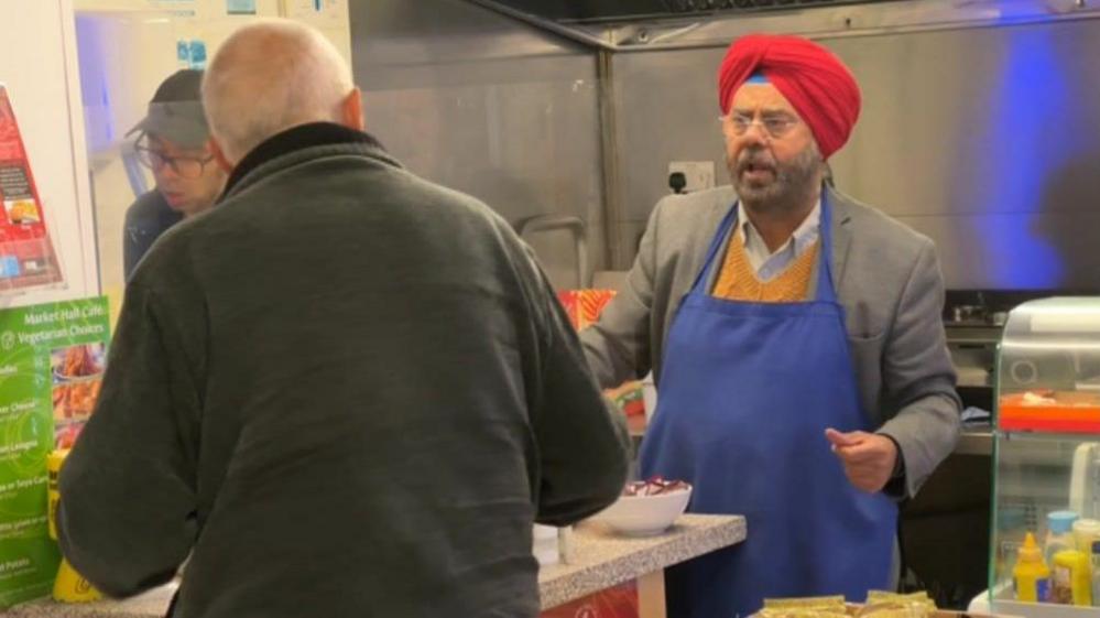 Lord Sahota working in wife's cafe