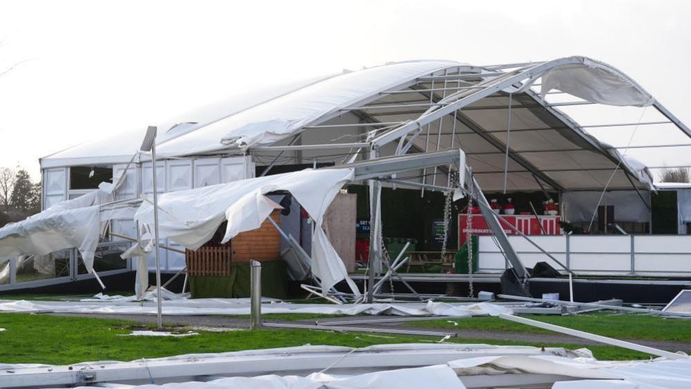 An ice skating facility with its roof ripped open and debris on the ground following damage caused by Storm Eowyn