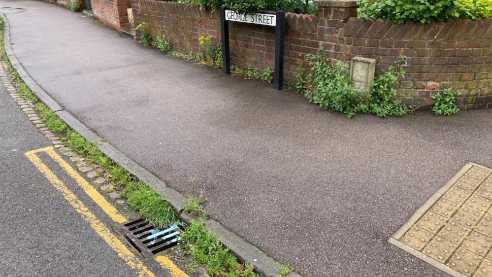 paint on a drain on George Street, Bedford