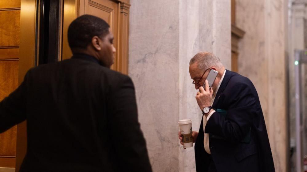 US Senate Minority Leader Chuck Schumer (R) enters the US Capitol with an impending government shutdown looming on 14 March