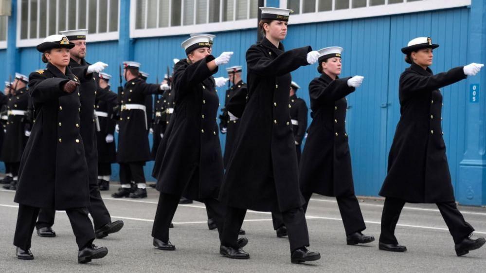 Female sailors of the Royal Navy wearing their distinctive uniforms marching