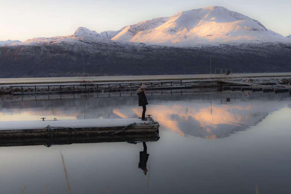 A woman standing on a pontoon in a lake