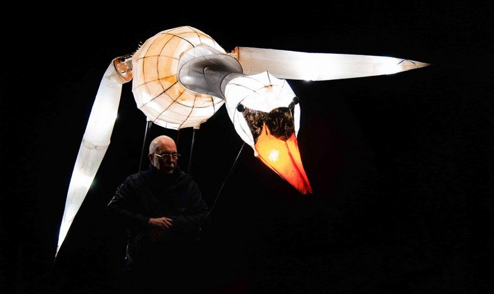 A man controls a model of a swan